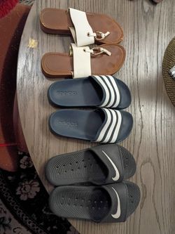 Four pairs of sandals or slides Adidas blue size 5 adult, Nike black size med. 5/6, Guess black size women's 6 and white between toe sandal size 6.5 w