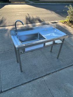 Brand new stainless steel utility sink with faucet and all the connections