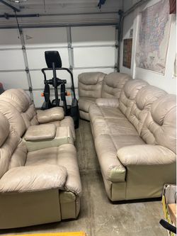 Tan leather sectional sofa, Elliptical machine and Desk
