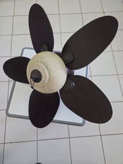 The 32-inch Hunter ceiling fan features five reversible blades offering a dark brown tone (such as cherry or walnut) on one side and a lighter finish 