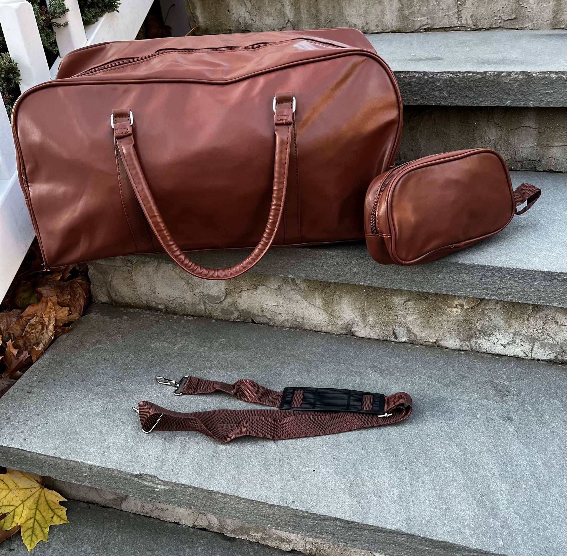 faux brown leather duffle bag with strap and toiletry bag
