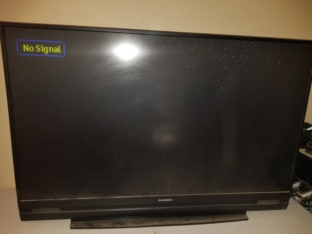 60 inch DLP Mitsubishi TV for sale. Has small white dots but still works and barely Visible when TV is on
