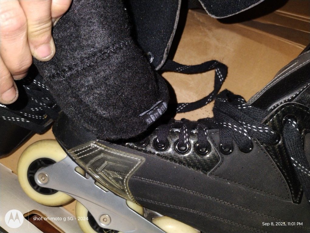 Hockey Skates And Two Sticks, One Stick Is Reebok And The Other I Believe Is Reebok/Nhl