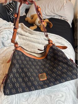 vintage Dooney & Bourke black monogram hobo shoulder bag with tan leather trim.