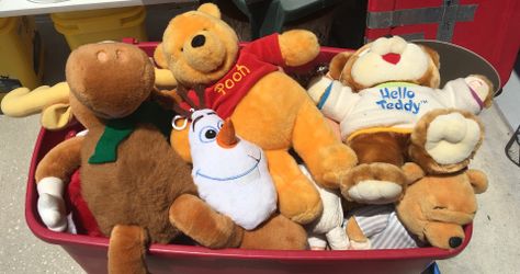 Box full of toys, teddy bears, and dolls