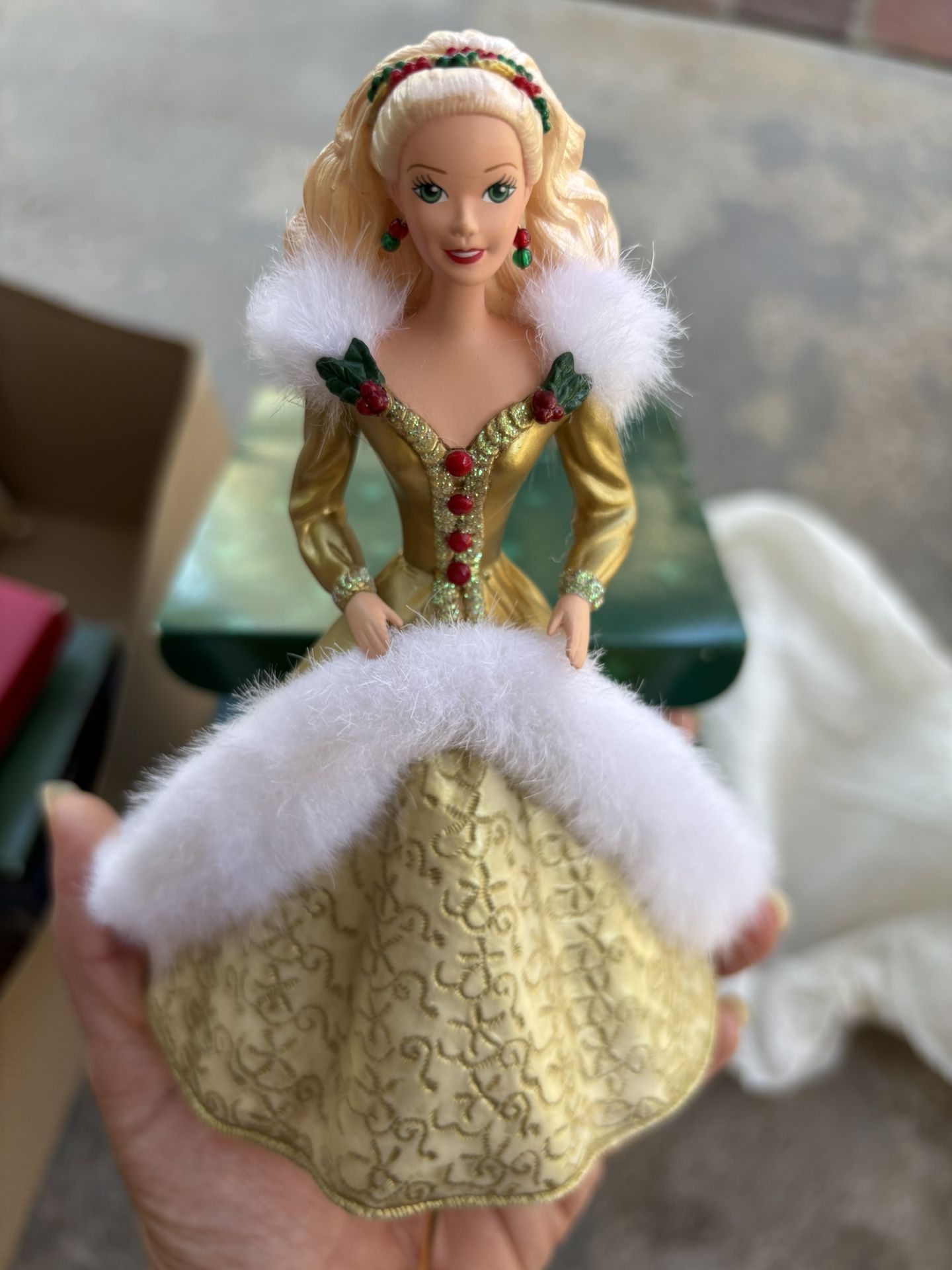 Christmas stocking hangar Barbie doll in a gold gown with white fur trim.