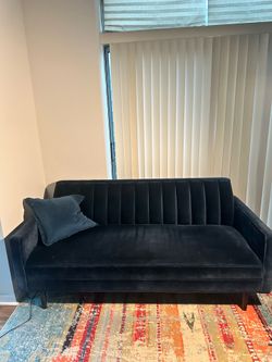 Two blue velvet couches