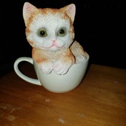 NEW CERAMIC CAT IN CUP. SOLID ALL THE WAY THROUGH.