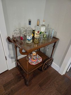 A vintage-style wooden serving cart or bar cart.