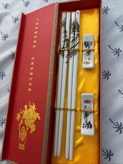 New Set of White Ceramic Chopsticks and Matching Chopsticks Rest featuring a Bamboo and a Panda Design Inside a Red Presentation Box