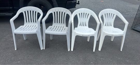 plastic chairs, two of them grey, and two of them white 4 plastic chairs, two of them grey, and two of them white