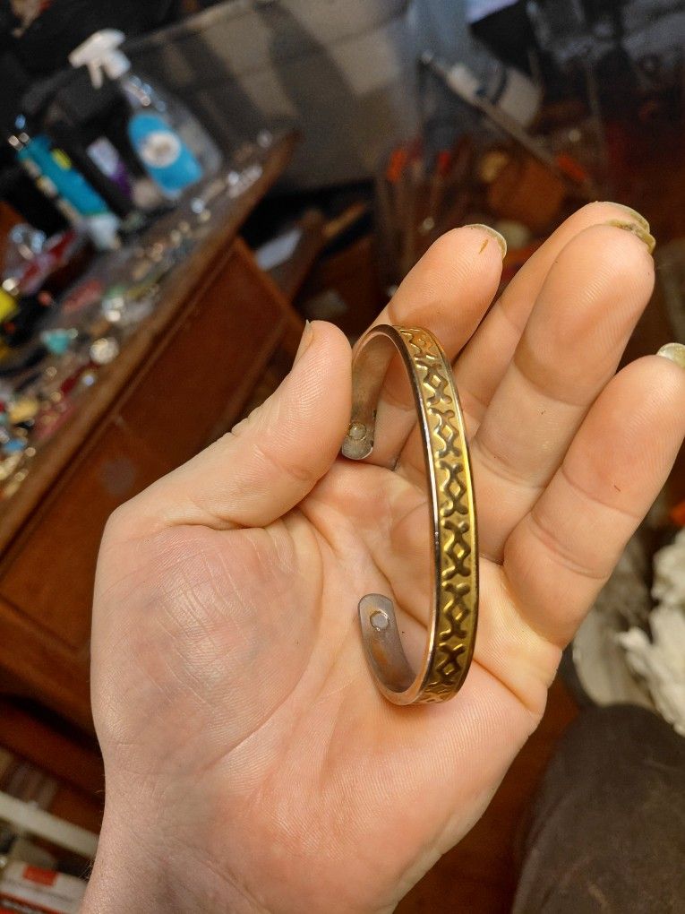 vintage gold and silver tone indented design cut bangle bracelet.