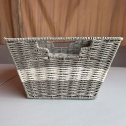 woven twisted paper rope  basket with a gray and white color block design and integrated handles.
