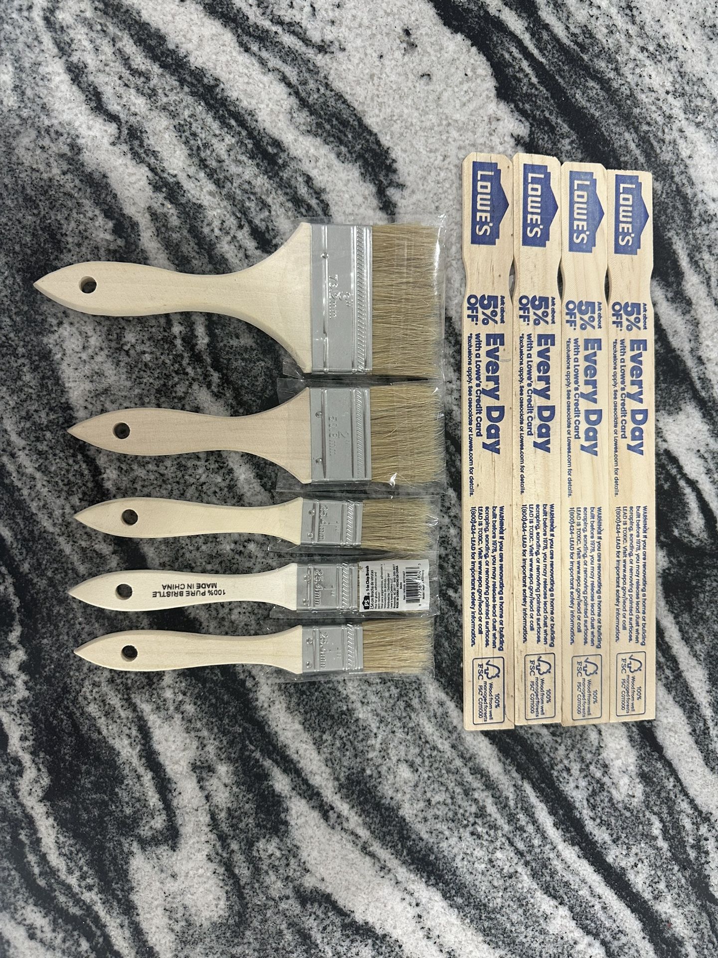 5 paintbrushes and 4 paint mixer sticks