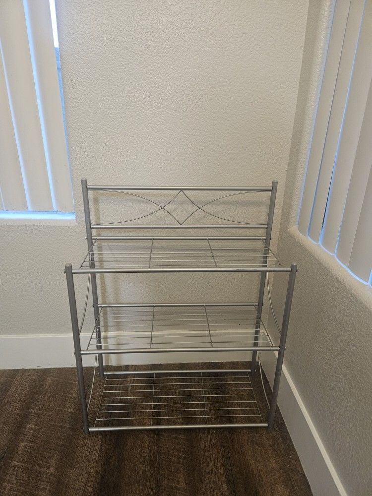 3-tier over-the-toilet storage shelf, designed to maximize storage space in bathrooms. 