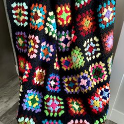 Vintage handmade crocheted groovy granny square afghan/blanket.  Nice large size at 79”x 54”. This one has ALL the colors. Background is black. 