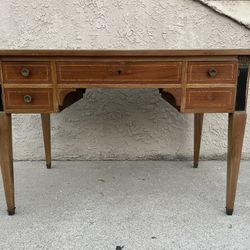 French Louis XVI neoclassical-style mahogany writing desk with a black leather top. 