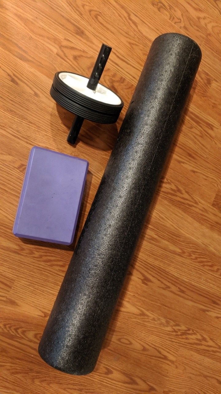 Assorted health goods, yoga block, an roller, and body roller