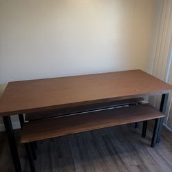Wooden table with steel beam legs and benches