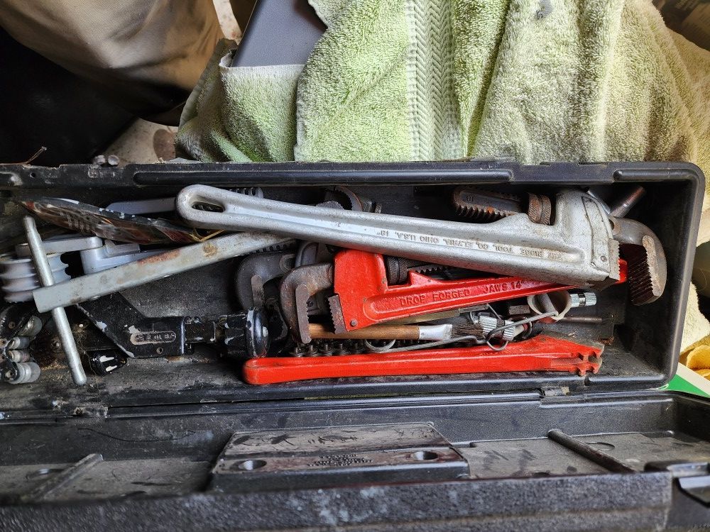 Assorted plumbing wrenches and tubing cutters
