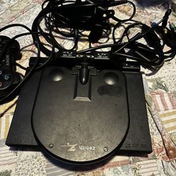 Sony PlayStation 2 Slim console with two controllers.