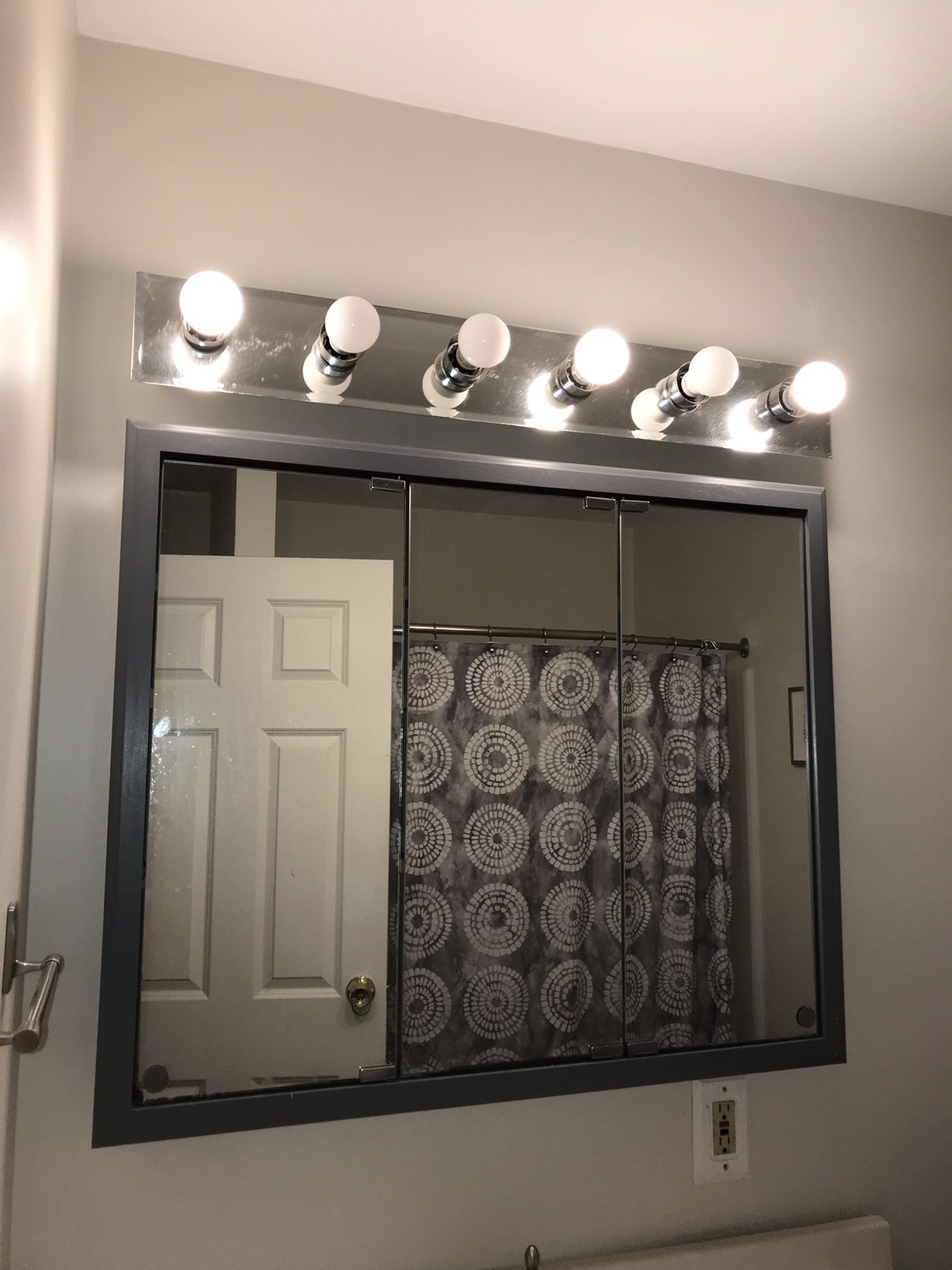 Bathroom 3 door mirrored cabinet and light fixture