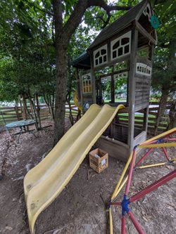 Play structure slides and climbing wall