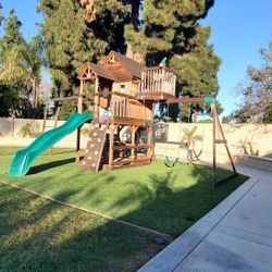 Two Story Playhouse With Swingset And Monkey Bars