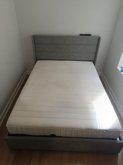 IKEA Mattress and Gray Upholstered Bed Frame