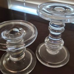 A pair of clear glass candle holders