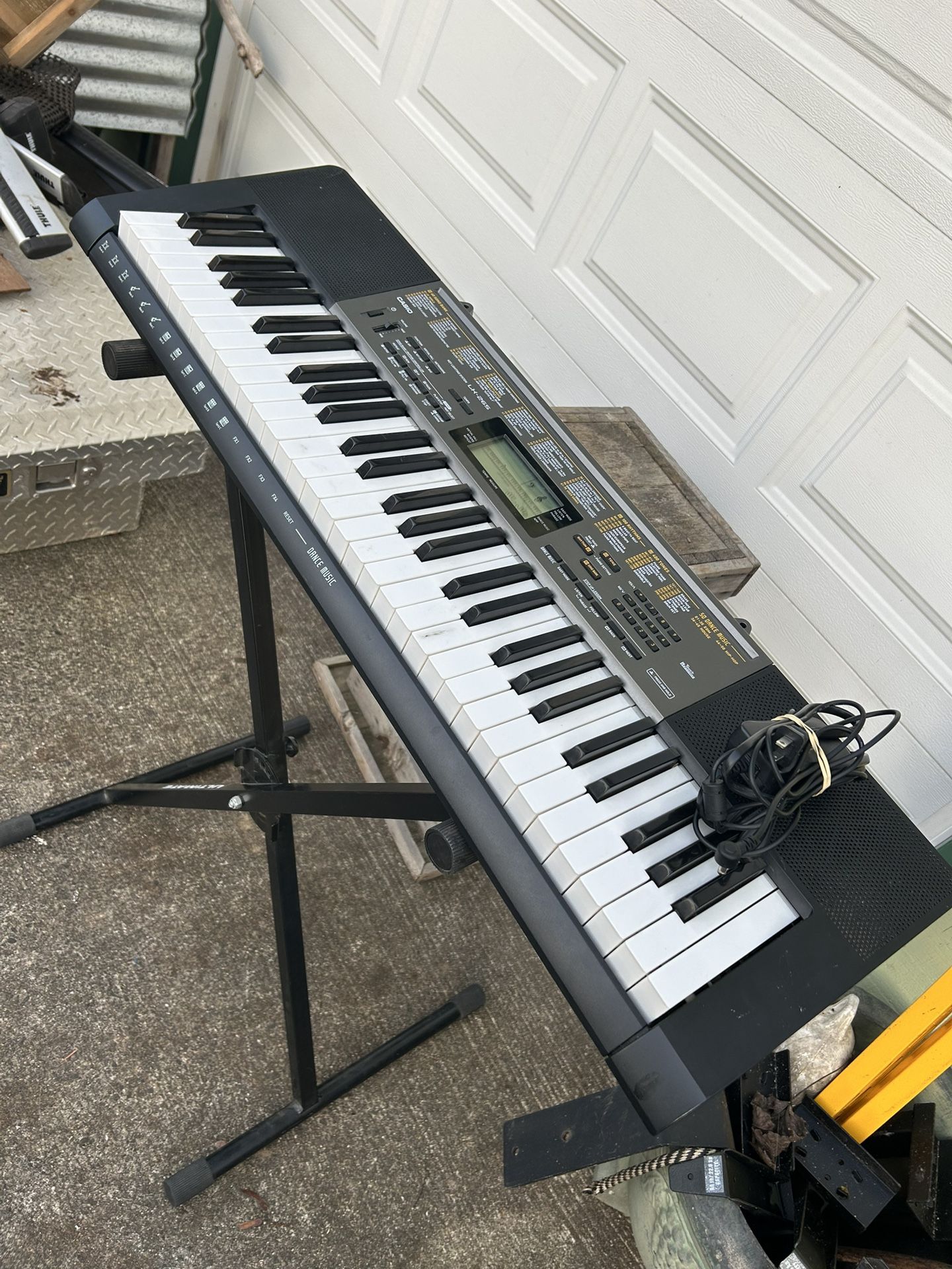 Casio LK-265 keyboard with keyboardstand and power supply-good condition. This is a really fun Keyboard and it has many many voices and songs, you can
