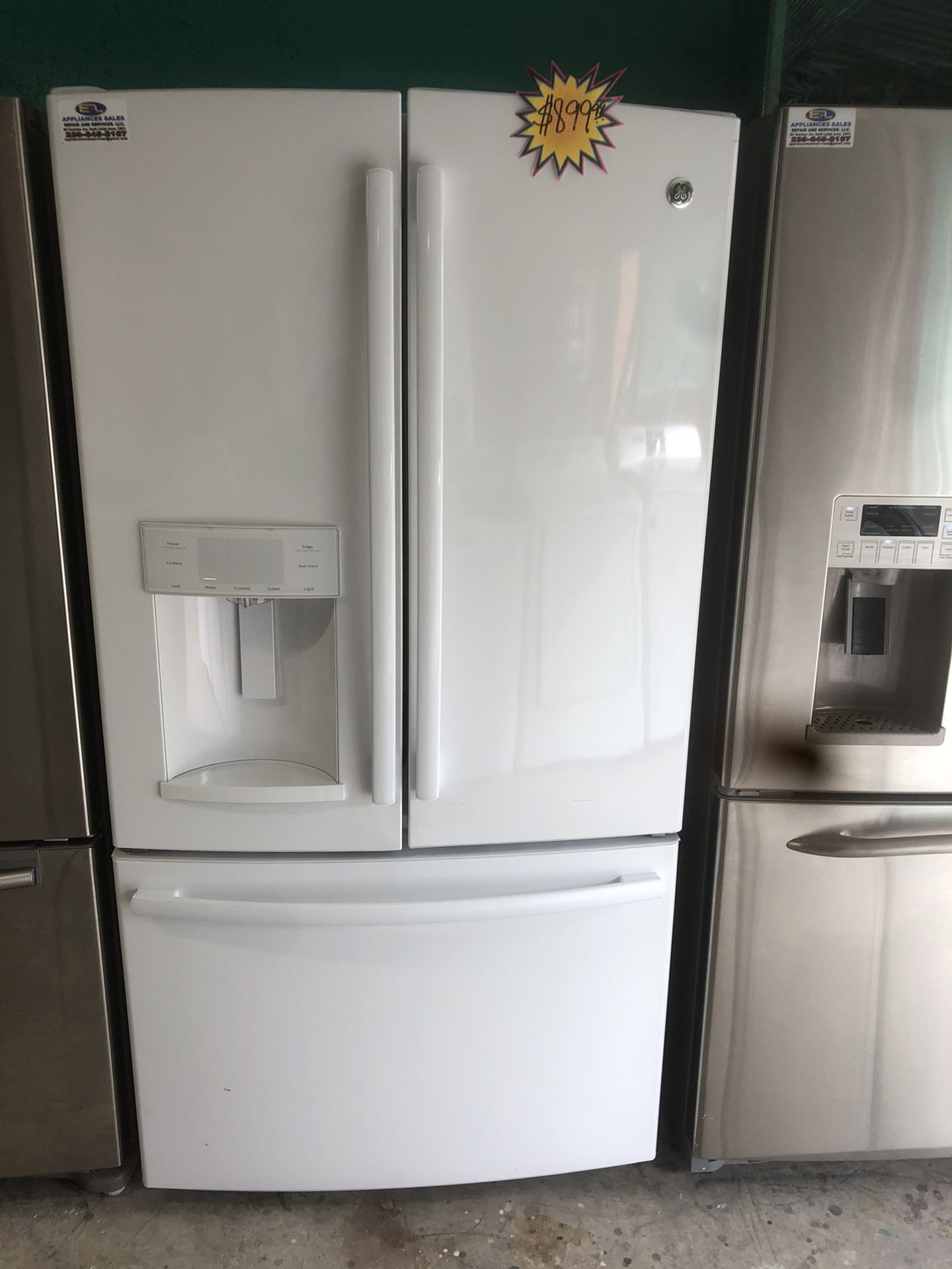 A white three door Ge refrigerator