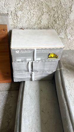 Three boxes of tiles and some pieces of granite.