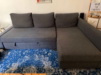 Gray couch with storage and fold out.