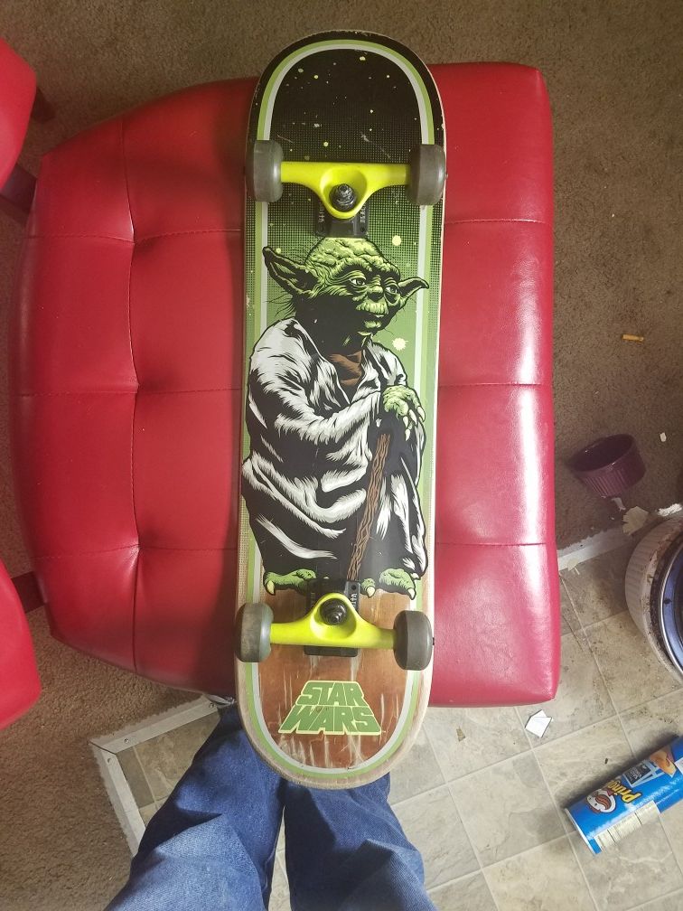 Vintage Santa Cruz Star Wars Yoda skateboard deck with blacksmith trucks and green bomber Wheels