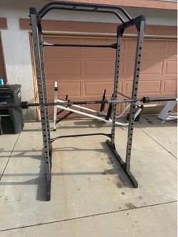 Very nice and strong squat rack with 7 ft Olympic bar. Perfect for squats, bench press, and pull ups. $300