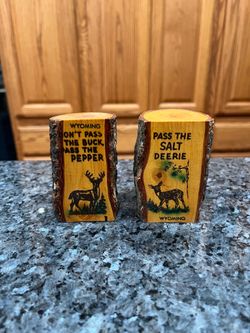 Vintage Souvenir Wyoming Wood Hand Carved pair of salt and pepper shakers.  Written on shakers “Don’t pass the Buck Pass the Pepper & Pass the salt De