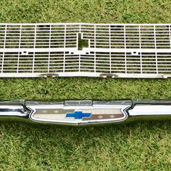 An  Original 1957 Chevy Center Bar And Grill With The Plastic Bow Tie  Insert And Pastic Light Covers.