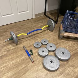 Curved barbell with set of weight plates
