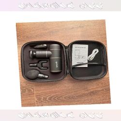 High-Power Tissue Massage Gun - Muscle Repair behind artist
