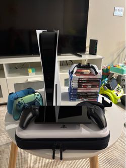 PlayStation 5 with PlayStation Portal, 2 extra controllers, controller charging dock, and games.
