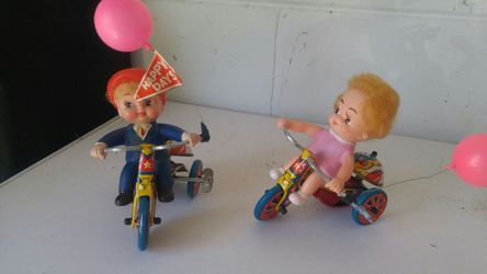 Mechanical boy and girl mechanical tricycle run wind up toy and there not replica the real deal.