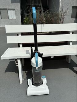 Amazon Basics upright bagless vacuum cleaner in black and white.