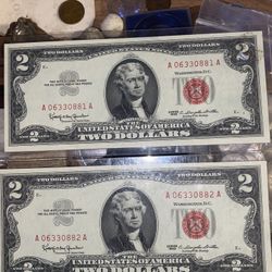 Two individual 2)$ bank bills from 1963 with the red seal  erial nubers *NSYNC