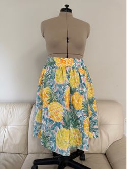 pineapple print A-line midi skirt features a vibrant tropical pattern in watercolor style