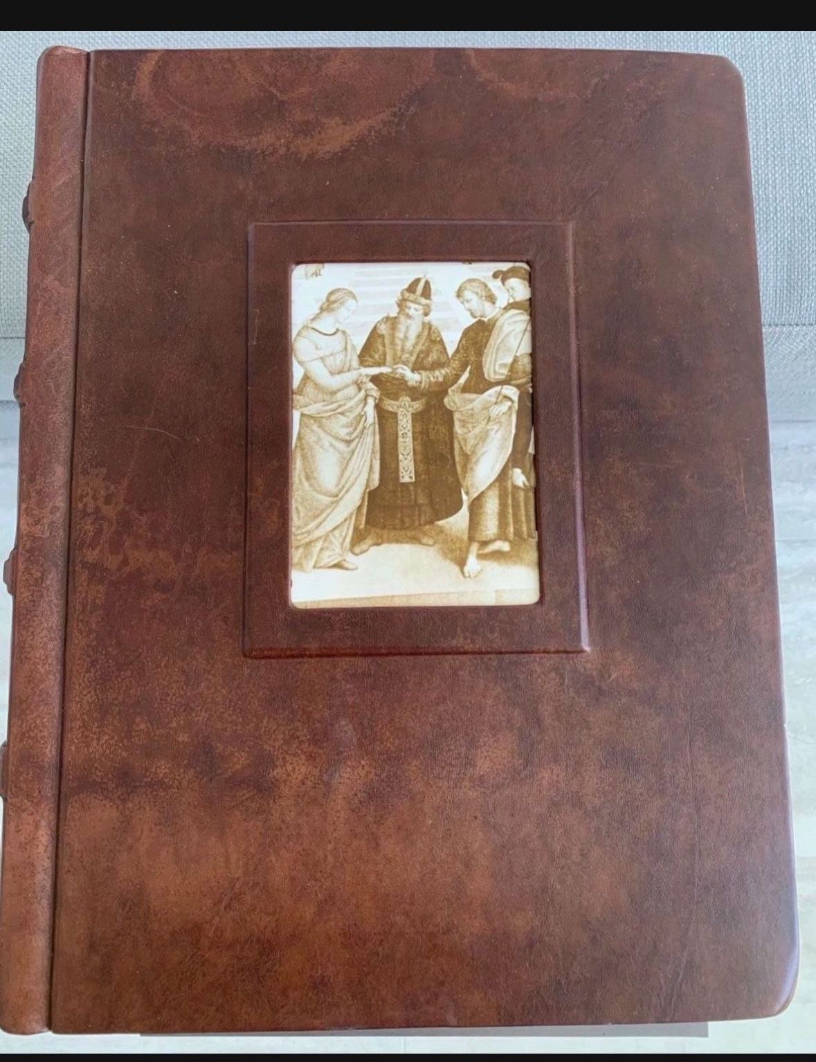 So Unique! Brown, leather bound 50 page scrapbook. Each page has a paper protective covering for items for the book. Never used Great condition.