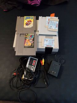 Nes console with two games and cleaner