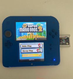 Blue Nintendo 2DS With Mario, Batman & Zelda