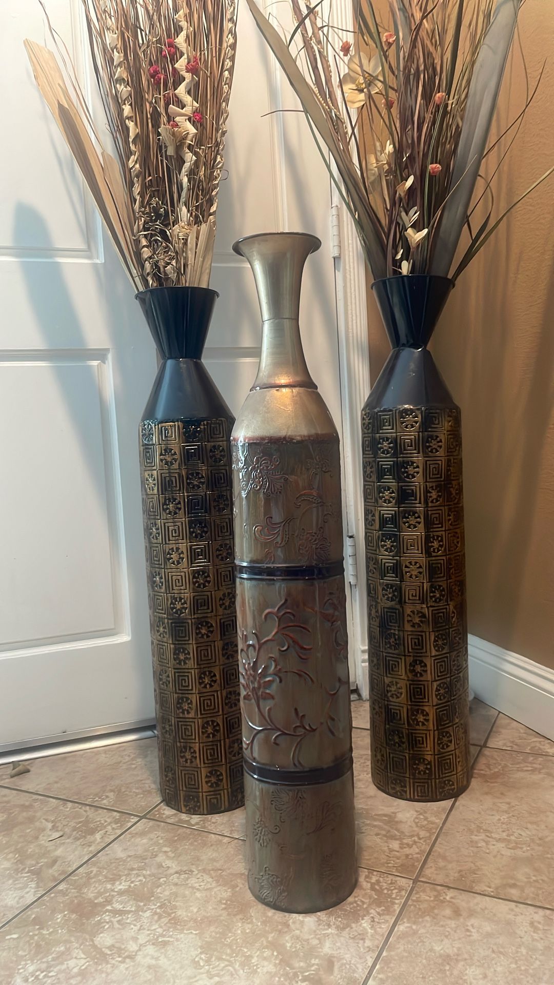 3 metal vases with foliage