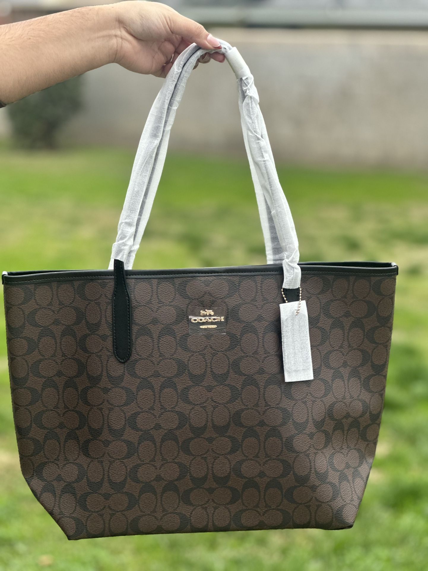 Coach City tote bags in classic signature print.